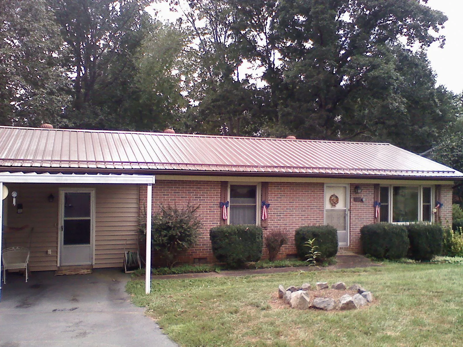 Bronze metal roof and carport on a brick ranch home — Roof Repair work by our crew in Hanover